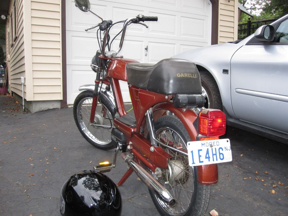 Red moped rear view with Garelli logo on seat and NJ license plate 1E4H6