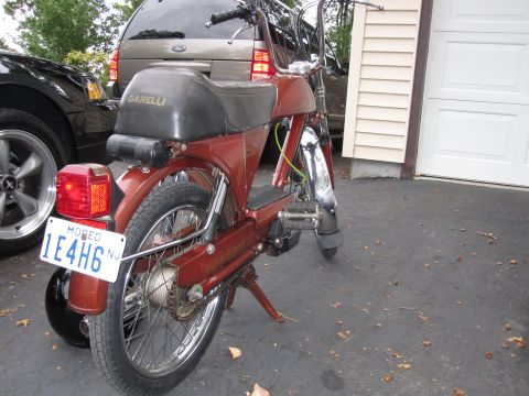 1981 Garelli Rally Sport - A red moped is parked in a driveway next to a black car and a tan SUV.