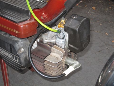 1981 Garelli Rally Sport - The engine of a red Garelli moped is shown in a close-up view, highlighting its mechanical components.
