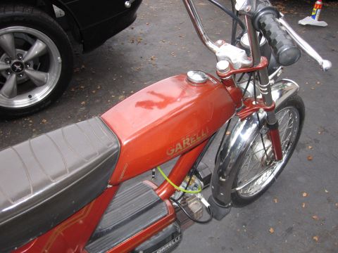 1981 Garelli Rally Sport - Close-up view of a red Garelli moped, showing its fuel tank and handlebars.