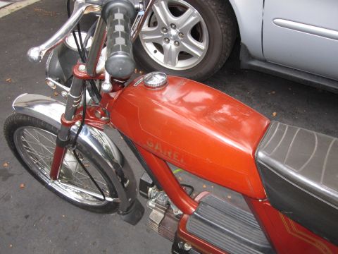 1981 Garelli Rally Sport - A close-up view of a red Garelli moped, showing its fuel tank and front wheel.