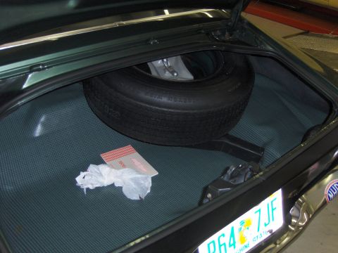 1979 Chevrolet Camaro - The trunk of the car contains a spare tire and a 1970 Chevrolet owner's manual.