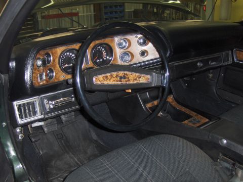 1979 Chevrolet Camaro - The interior of a 1979 Chevrolet Camaro shows its classic dashboard and steering wheel with woodgrain accents.