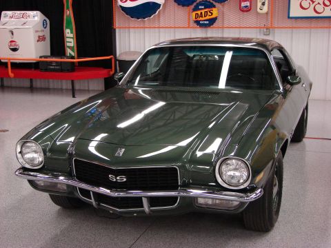 1979 Chevrolet Camaro - Front view of a 1979 Chevrolet Camaro SS, parked indoors with vintage advertising signs in the background.