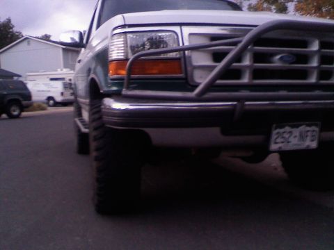 1996 Ford Bronco - A close-up view of the front of a Ford truck, showing its bumper and brush guard.