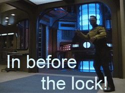 1995 Ford Bronco - A man in a yellow Starfleet uniform stands in a room with blue illuminated panels and consoles.