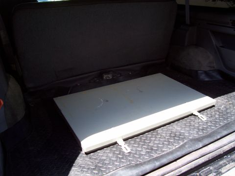 1994 Ford Bronco - Interior view of the rear storage area of a 1994 Ford Bronco, showing a removable panel.