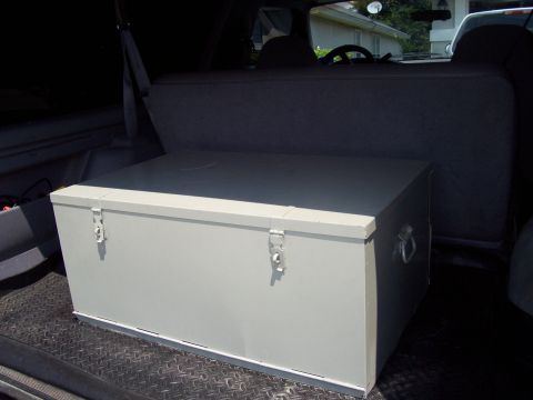 1994 Ford Bronco - Interior view of a gray storage box placed in the rear cargo area of a vehicle.