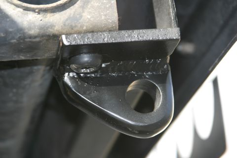 1987 Suzuki Samurai - Close-up of a black metal tow hook bracket, showing its construction and mounting hole.