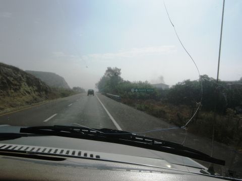 1986 Ford Bronco - View from inside a vehicle driving on a highway with a sign for 'PUENTE MENDO' visible.