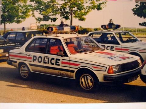 1991 Ford Crown Victoria - Multiple police cars are parked together, one in the foreground with "POLICE" text and a light bar on its roof.