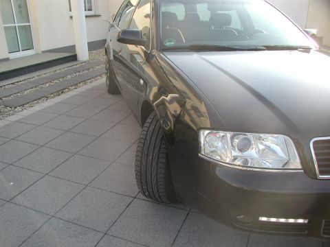 2003 Audi A6 - A dark 2003 Audi A6 is parked on a tiled driveway, showing its front quarter.