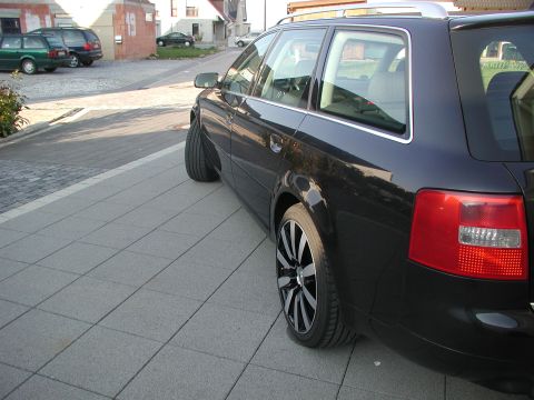 2003 Audi A6 - This black 2003 Audi A6 wagon is seen from the rear quarter angle, parked on a paved street.