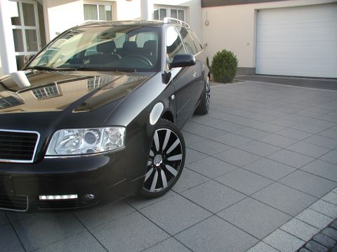 2003 Audi A6 - Front 3/4 view of a black 2003 Audi A6 Avant wagon parked on a paved driveway.