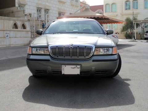 2001 Mercury Grand Marquis - This 2001 Mercury Grand Marquis features a distinctive chrome grille and a front-facing view, complete with a license plate from Kuwait.