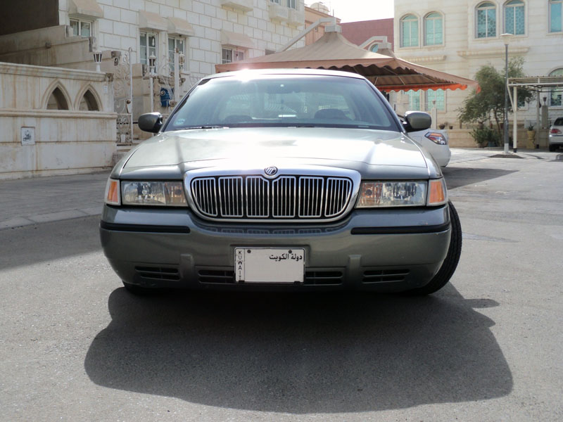 Front view of gray-green Mercury Grand Marquis with a Kuwait license plate