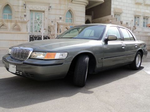 2001 Mercury Grand Marquis - A gray 2001 Mercury Grand Marquis is shown from the front three-quarter view, parked on an asphalt surface.