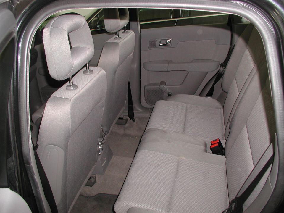 Gray fabric car interior showing rear seats, door panels, and headrests