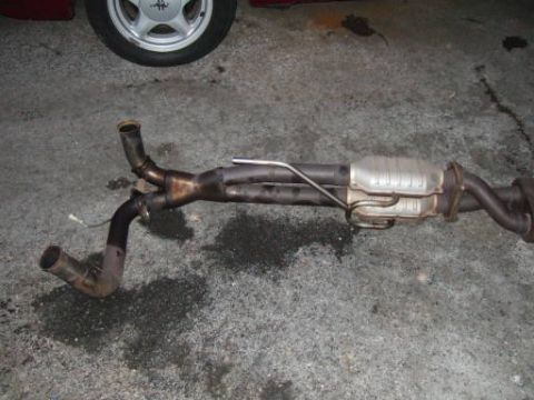 1986 Ford Bronco - Exhaust system with catalytic converter and dual pipes, likely removed from a vehicle.