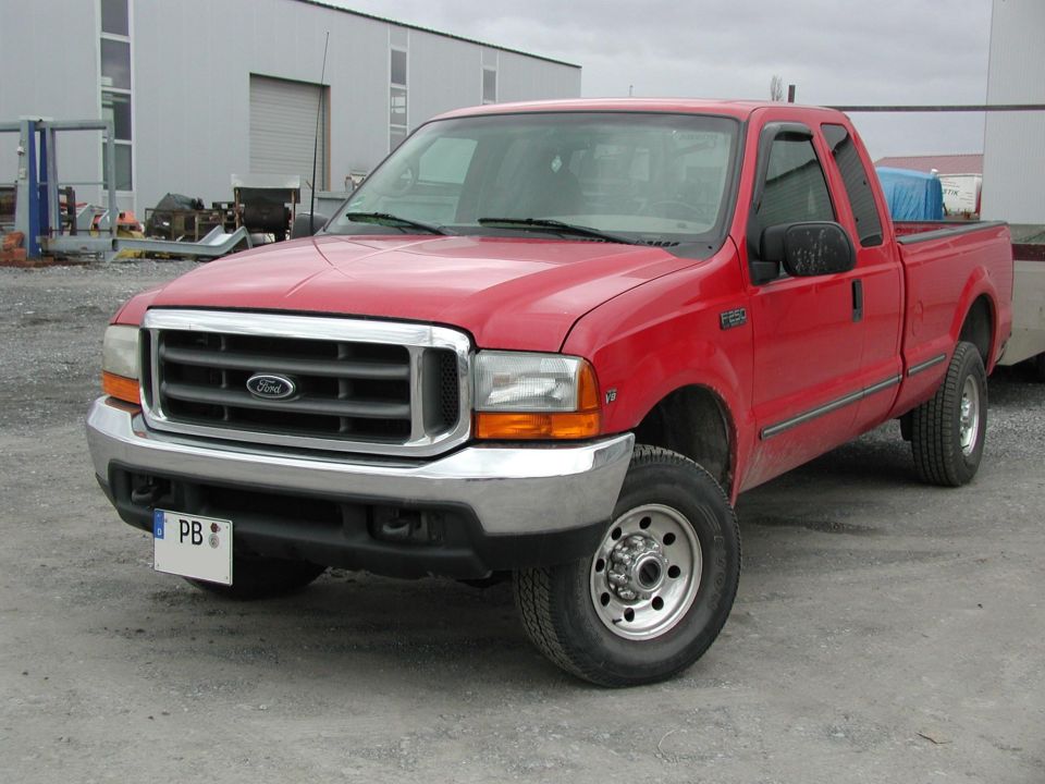 Red Ford F-250 truck, front 3/4 view, chrome grille, visible 'F250' badge