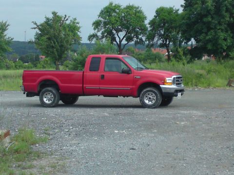1999 Lincoln Town Car - This red pickup truck is not a 1999 Lincoln Town Car.