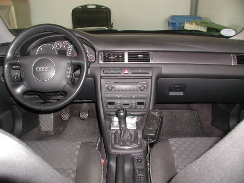 2003 Audi A6 - The interior of a 2003 Audi A6, showing the dashboard, steering wheel, and gear shifter.