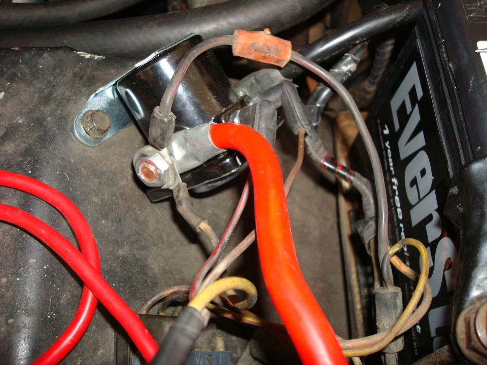close-up of car battery terminals and red and black wires