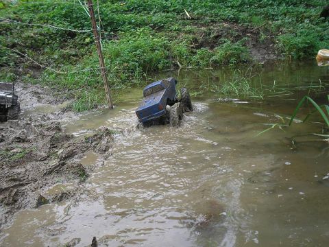 1994 Ford Escort - Toy RC trucks navigating a muddy obstacle course.
