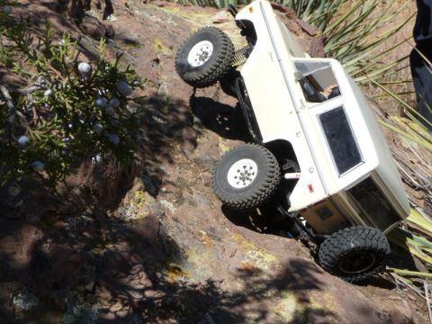 1988 Ford Bronco - A toy truck navigates a rocky incline in a desert environment.