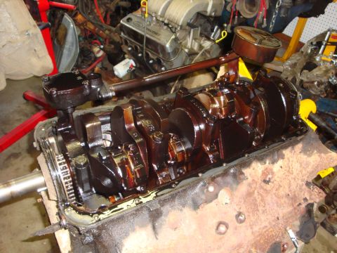 1989 Ford Bronco - Close-up of an engine block's internal components, with a Ford Racing intake manifold in the background.