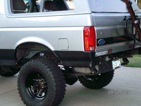 1996 Ford Bronco - Rear view of a 1996 Ford Bronco showing the quarter panel, large off-road tires, and suspension.