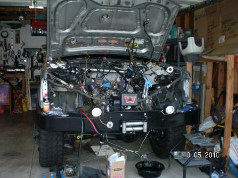1996 Ford Bronco - 1996 Ford Bronco engine bay during modification, hood is open.