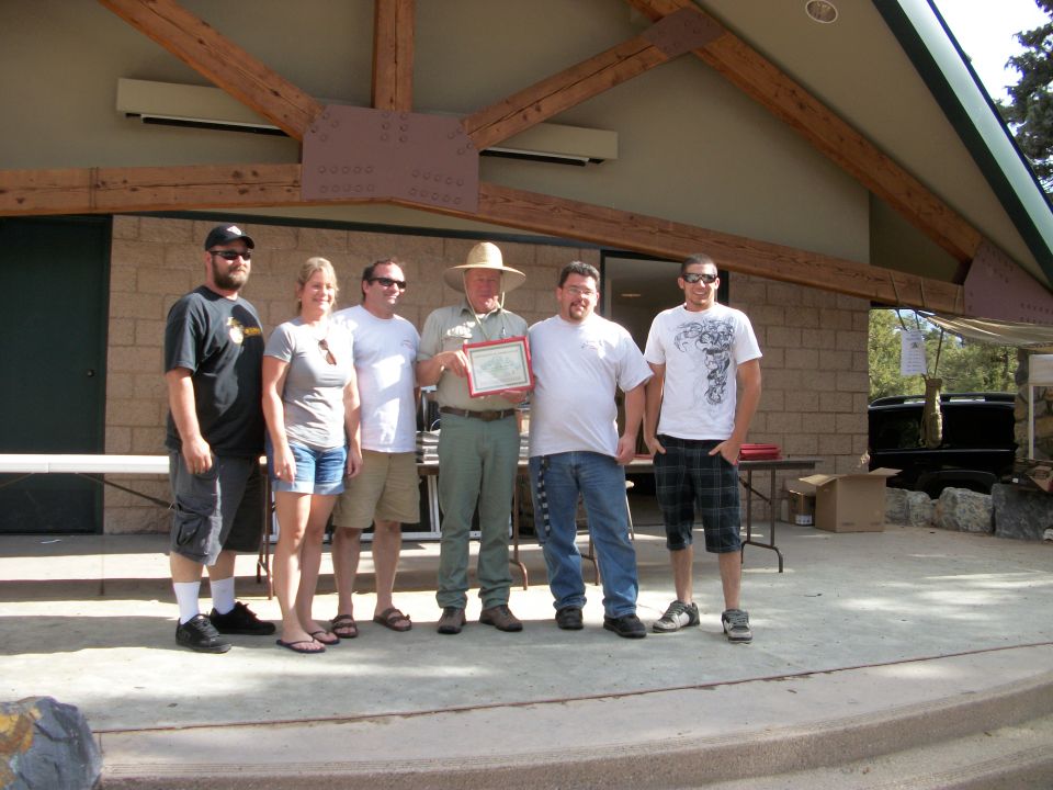 Group receiving an award outdoors