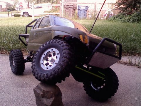 1996 Ford Bronco - This remote control rock crawler truck features large, aggressive tires and a custom roll cage, designed for off-road terrain.