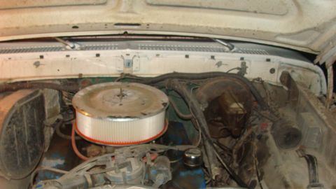 1978 Ford Bronco - The engine bay of a 1978 Ford Bronco shows various components and hoses under the hood.