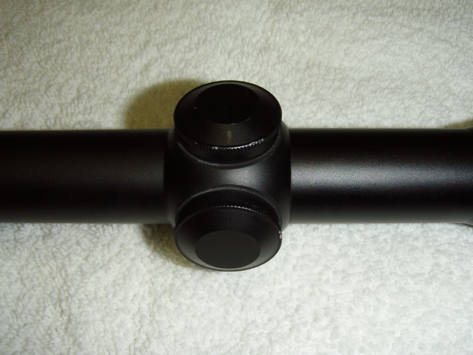 Close-up of a black rifle scope with turrets