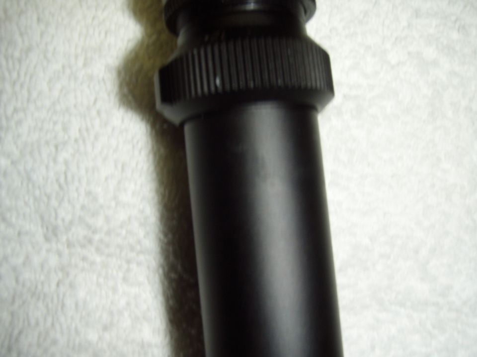 Black motorcycle part with ribbed collar and smooth cylinder