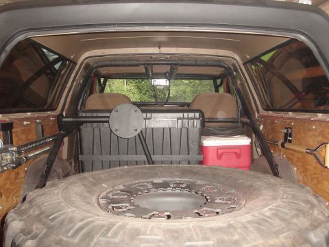 1989 Ford Bronco - The interior of this 1989 Ford Bronco features a custom tire carrier and spare tire mounted in the cargo area.
