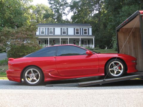 1994 Ford Probe - Red 1994 Ford Probe is being loaded onto a trailer.
