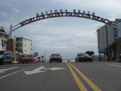 1994 Ford Probe - Cars drive under the iconic Daytona Beach archway, a landmark on the world's most famous beach.