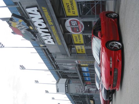 1994 Ford Probe - A red 1994 Ford Probe is parked outside Daytona International Speedway.