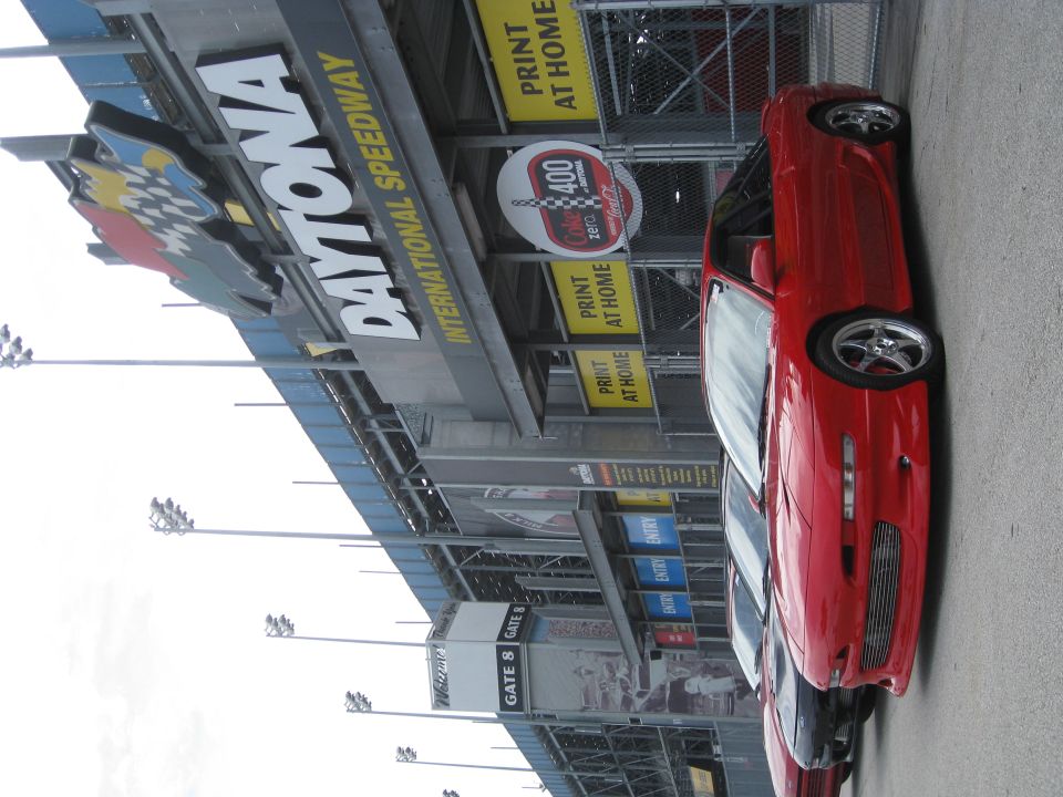 Red 1994 Ford Probe parked at Daytona International Speedway, 3/4 front view