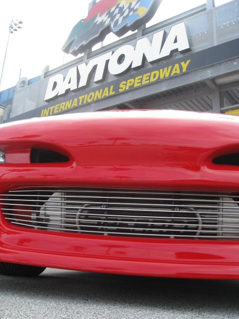 1994 Ford Probe - Front view of a red car parked at Daytona International Speedway.