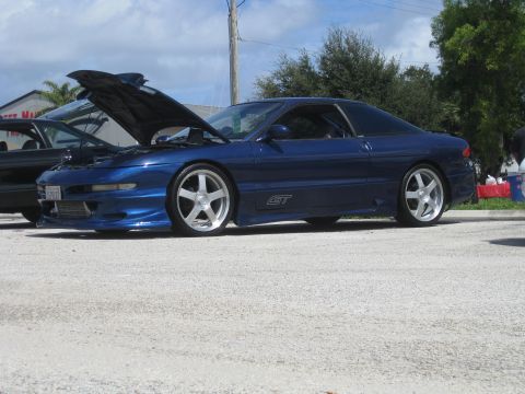 1994 Ford Probe - A blue 1994 Ford Probe GT is parked with its hood open, showing the engine bay.