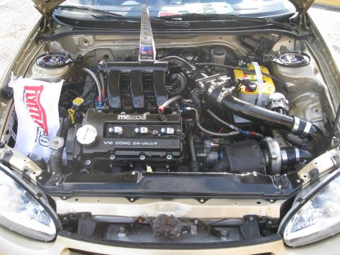 1994 Ford Probe - Engine bay view shows a modified Mazda V6 DOHC 24-valve engine with turbocharger and Optima battery.