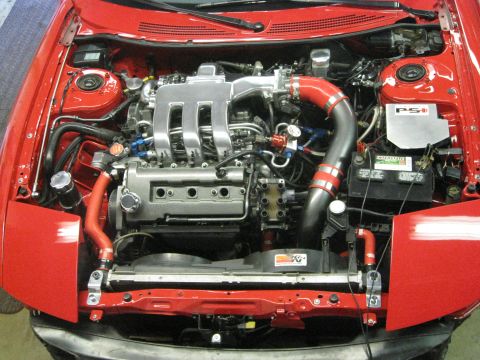 1994 Ford Probe - Engine bay of a red car, showing the V6 engine and associated components.
