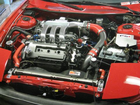1994 Ford Probe - The engine bay features a modified intake system and vibrant red hoses, with a PSI sticker visible.