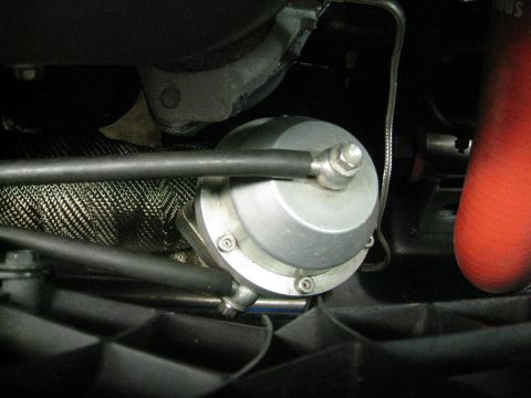 1994 Ford Probe - Close-up of a turbocharger wastegate, a component of a vehicle's exhaust system.