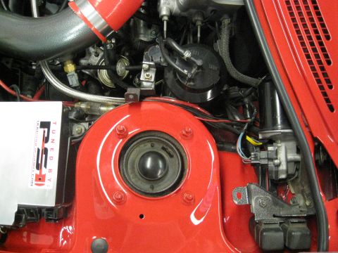1994 Ford Probe - This image shows various engine components, including a red intake hose and a silver tuning box.