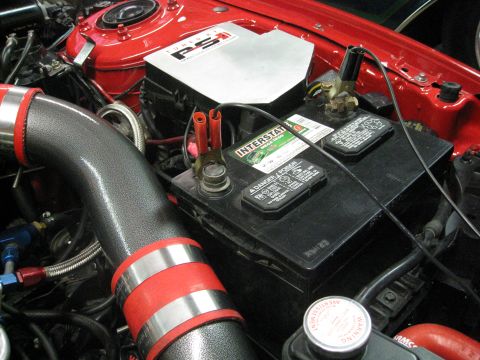 1994 Ford Probe - Engine bay detail an Interstate battery and aftermarket intake piping.